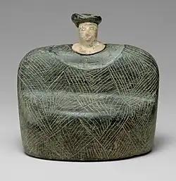 Seated figurine (Bactrian); 3rd-2nd millennia BC; chlorite and limestone; height: 9 cm; Metropolitan Museum of Art (New York City)[82]