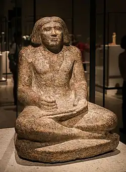 Seated portrait statue of Dersenedj, scribe and administrator; c. 2400 BC; rose granite; height: 68 cm; from Giza; Egyptian Museum of Berlin
