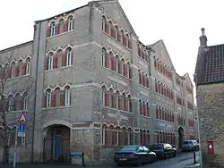 Corner of four-storey building with multiple matching arched windows