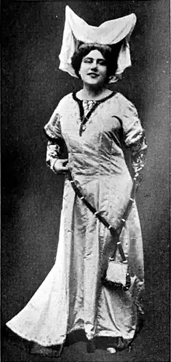 An actress in an elaborate head-dress and peasant costume