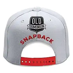 A white snapback hat with red strap is centered on the white background with the title colored in red and the band's logo above it.