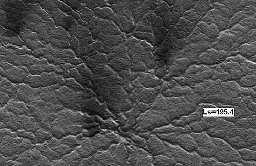 Some spider 14 Martian days later, as seen by HiRISE. Notice increased dark fans caused by outgassing of carbon dioxide and dark material.