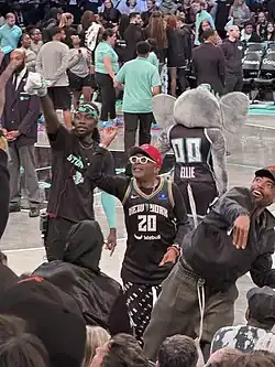 Filmmaker and Basketball Superfan Spike Lee on the basketball court during a break in the game play, helping throw T-shirts into the crowd at Barclays Center Arena in Brooklyn, NY
