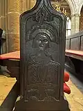 Nave pew end carved with a bearded figure