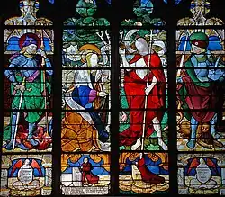 Stained glass depicting St. George, Mary Magdalene, Christ, and St. Adrian (left to right)