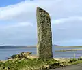 The Stenness Watch Stone stands outside the circle, next to the modern bridge leading to the Ring of Brodgar