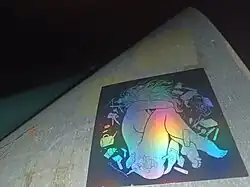 A sticker by the artist "Onnie" on the back of a street sign in Sydney. 2025.