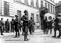 SS and police officers look on as SS Major General Juergen Stroop discusses razing the houses on Niska and Muranowska Streets with Kaleschke, his police adjutant, during Warsaw Ghetto Uprising
