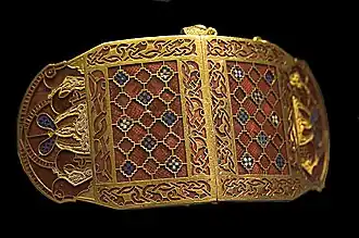 Shoulder-clasps from Sutton Hoo; early 7th century; gold, glass and garnet; length: 12.7 centimetres (5.0 in); British Museum (London)