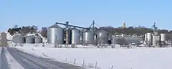 Tarnov seen from the east. In the foreground are grain bins along the Nebraska Central Railroad track; on the hill right of center is the steeple of St. Michael's Catholic Church, February 2010