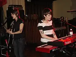 Two women with black hair singing