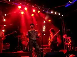 Joel Gion (centre) performing with The Brian Jonestown Massacre