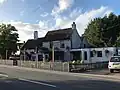 The Chequers pub, listed at grade II[4]