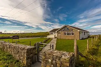 Single-story building with the name "Am Politician" on the front