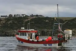 Fishing boat "shooting" a line of creels