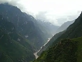 A narrow river gorge between mountains covered in forest