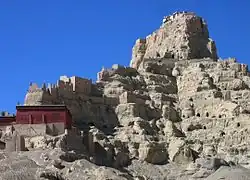 Earthen buildings on the slope of a hill with tulin landforms
