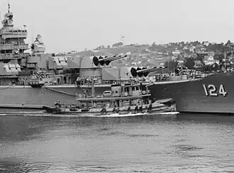 USS Awatobi (YTB-264) assists USS Rochester in departing Mare Island Naval Shipyard on 20 September 1953.