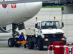 A Unimog being used as a pushback tractor