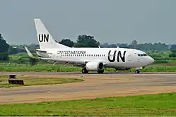 A passenger jet aircraft with a large "UN" painted on it