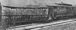 Two streetcars being burned