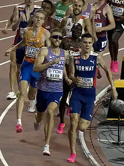 Photo of Josh Kerr and Jakob Ingebrigtsen running side by side ahead of ten other runners