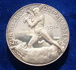 Reverse of a German silver medal commemorating the liberation of East Prussia in 1914 by Paul von Hindenburg. The naked General Hindenburg is fighting the Russian Bear with his sword.