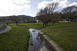 Photo of stream in concrete chanel in a park