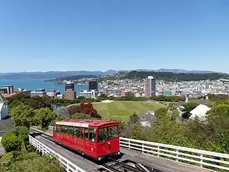 View of Wellington Cable Car, Kelburn Park sports field and central business district, from the Botanic Garden