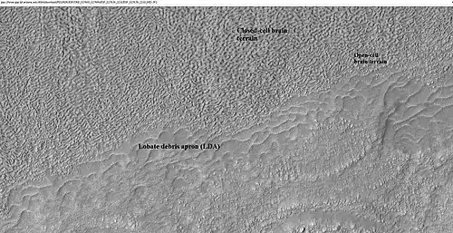 Close-up of lobate debris apron from the previous CTX image of a mesa. Image shows open-cell brain terrain and closed-cell brain terrain, which is more common. Open-cell brain terrain is thought to hold a core of ice. Image is from HiRISE under HiWish program.