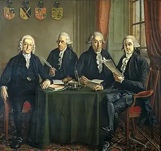 Group portrait of the four chief commissioners of the ports, quays and cranes in Amsterdam, sitting around a table