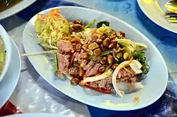 Yam naem is a Thai salad prepared with naem and other ingredients.