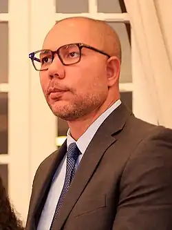 A photograph of Yamil Bukele wearing a business suit