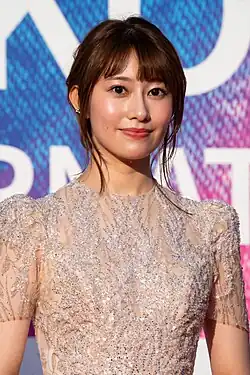 waist up portrait of Sakurai wearing sequined dress, directly facing camera