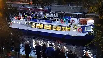 the team on a small cruise boat on a river