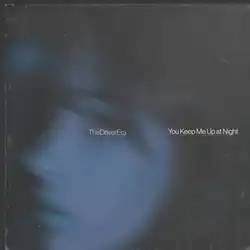 The cover depicts a girl's left side profile. The picture features a dark moody blue the the band and song's name appearing in her cheeks.